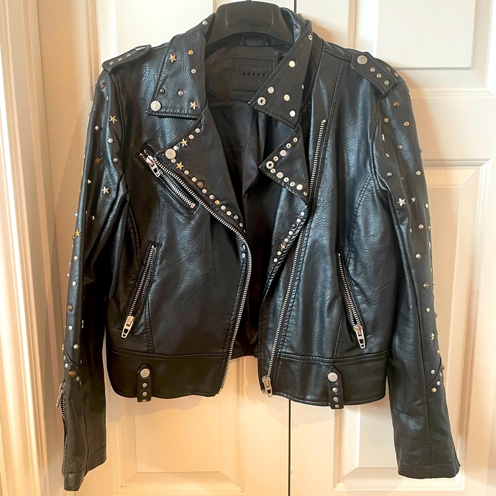 Worn once. Edgy, faux leather jacket with metal details
